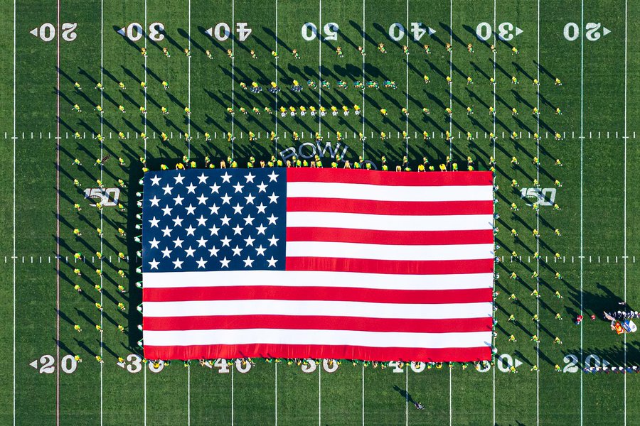 Blog image of the Oregon Marching Band (OMB) holding an American Flag on the field of the 106th Rose Bowl Game