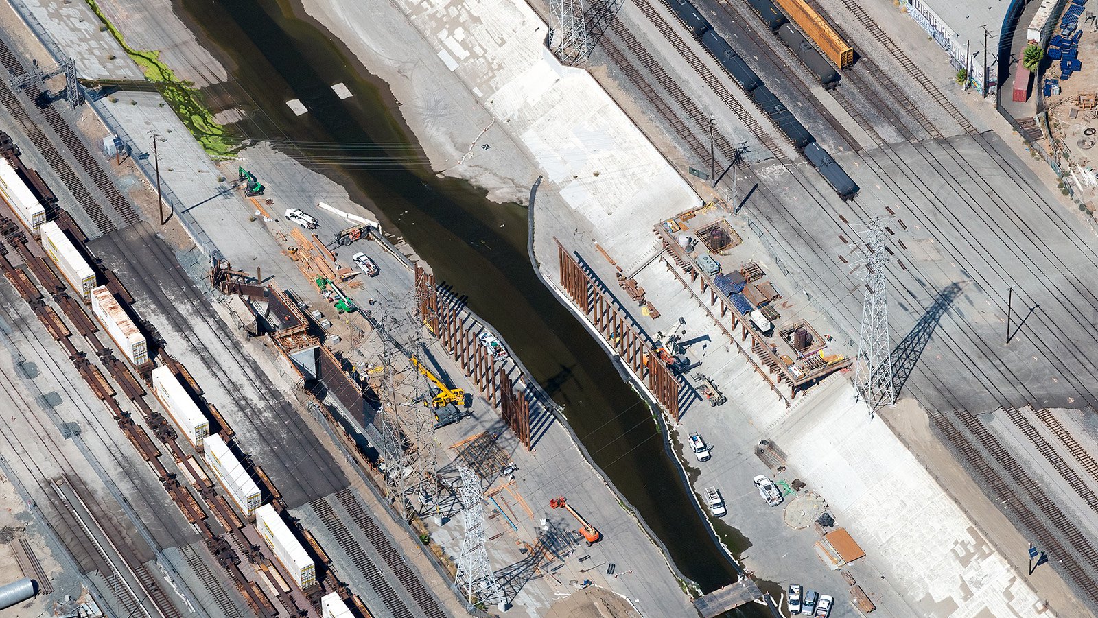 Aerial photograph of the Sixth Street Bridge construction as the initial supports are installed on opposite sides of the Los Angeles River