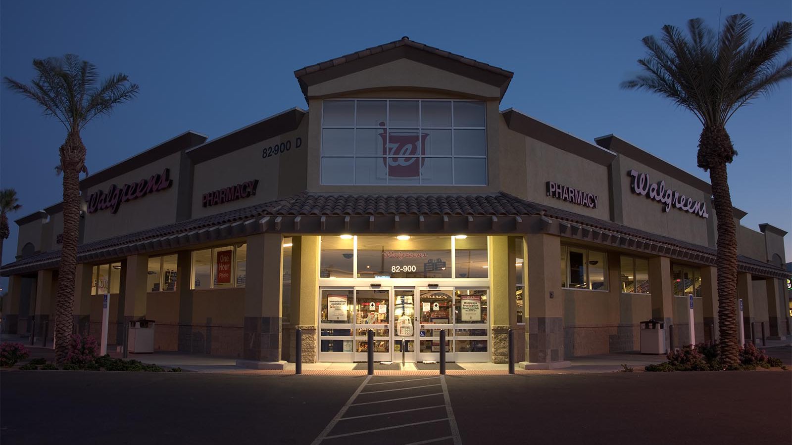 RAW exterior architectural photograph of a Walgreens store at sunrise