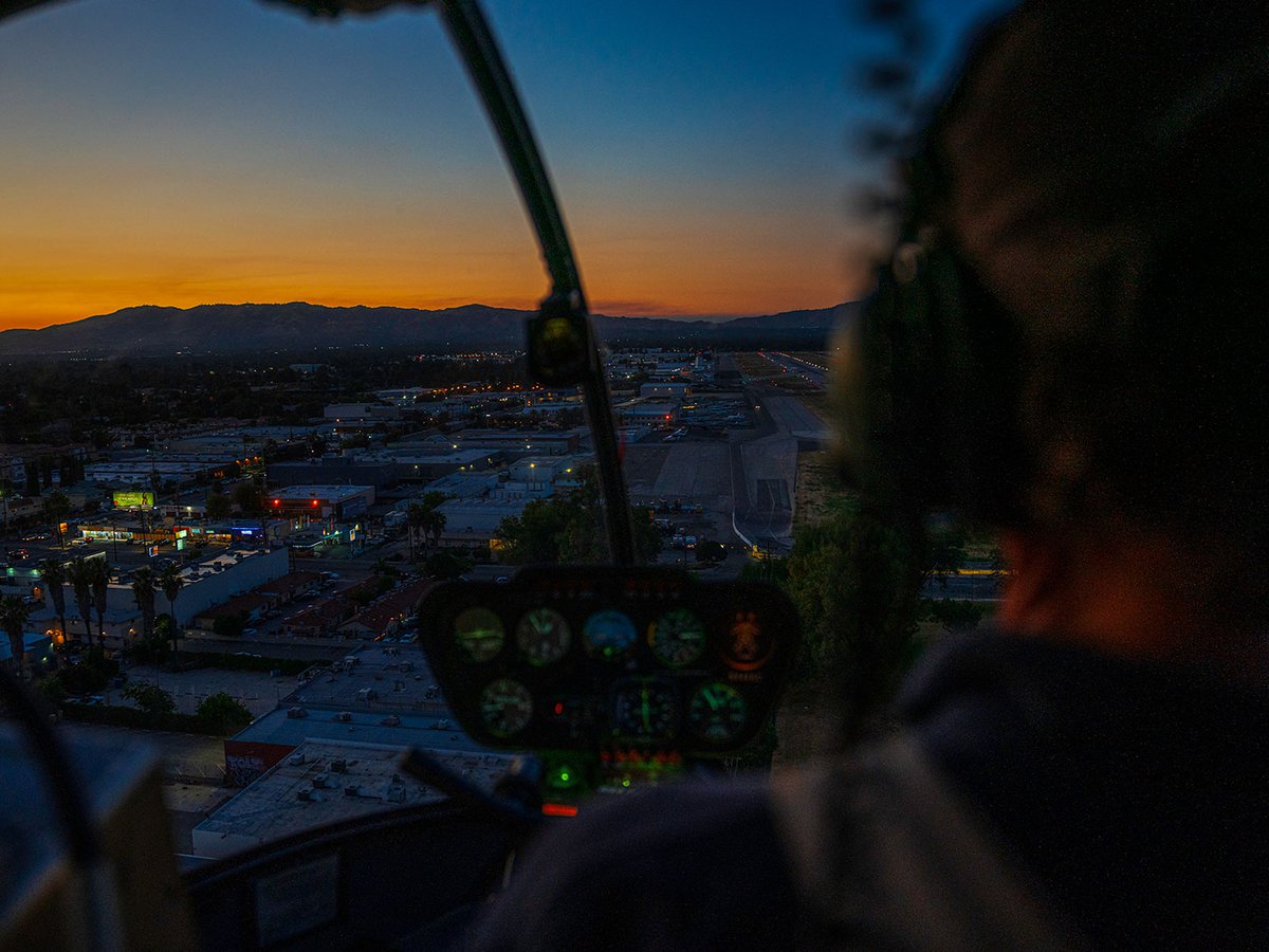 Blog image of cockpit view over Van Nuys, California, during sunset helicopter flight