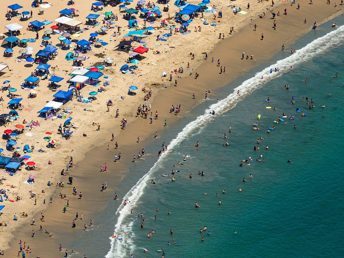 Blog image of crowds in Newport Beach, California crowding the beach on a hot summer day