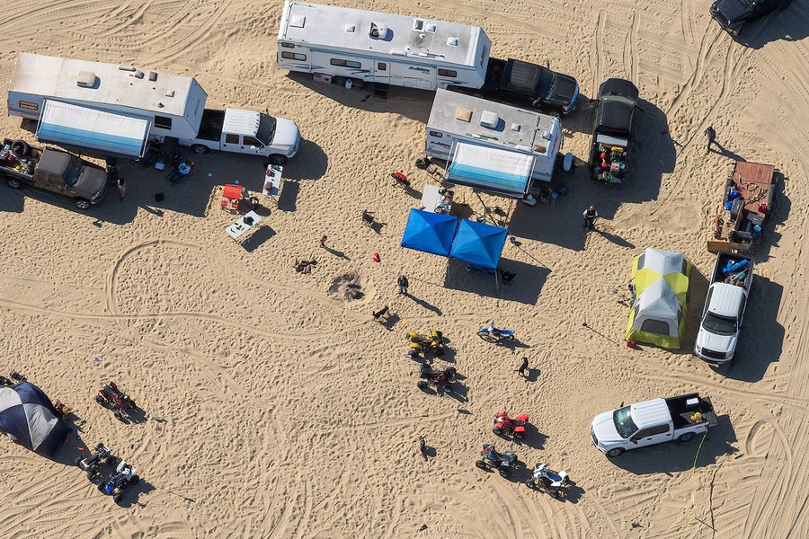 Blog image of thrillcraft owners with quads, pickups, tents and RVs making camp at the Oceano Dunes Vehicular Recreation Area near Pismo Beach, California