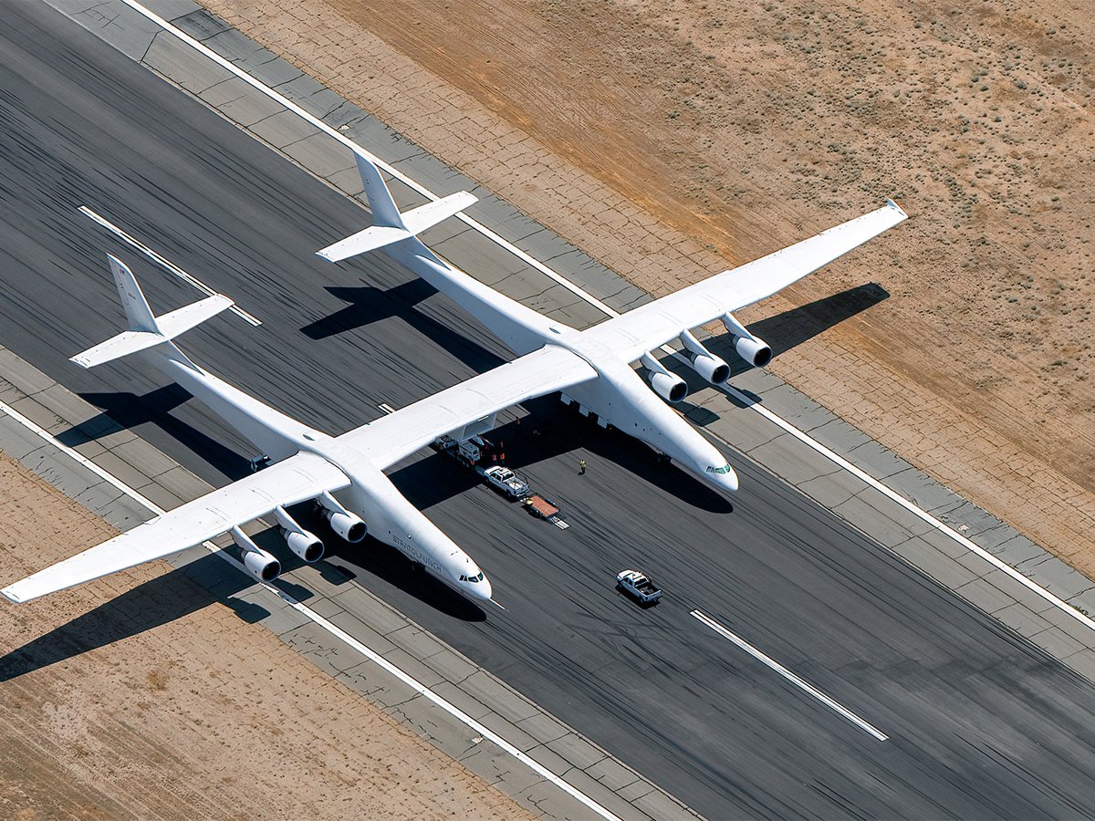 Stratolaunch Roc sits ready on the tarmac, as seen from above, embodying the future of aerospace technology at Mojave Air & Space Port.