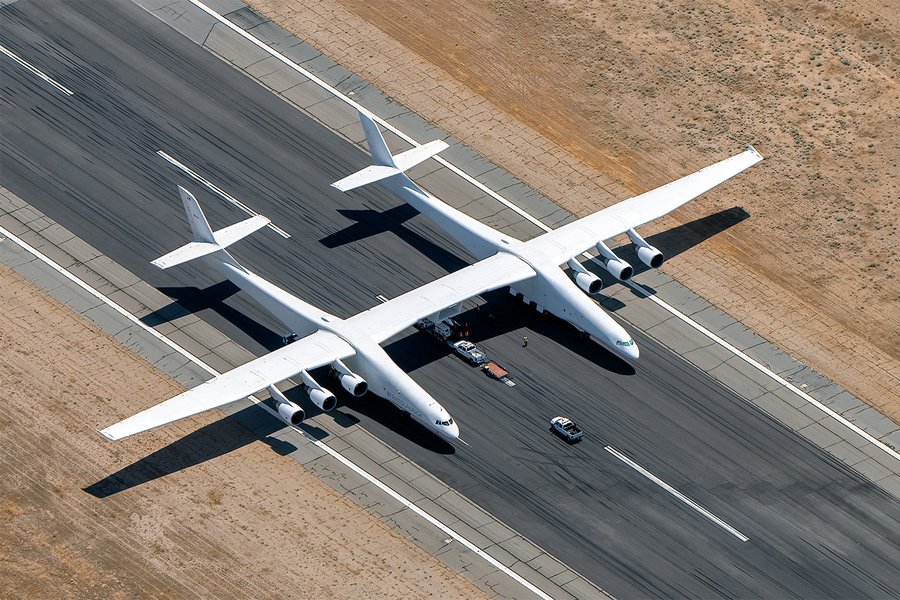 Stratolaunch Roc sits ready on the tarmac, as seen from above, embodying the future of aerospace technology at Mojave Air & Space Port.